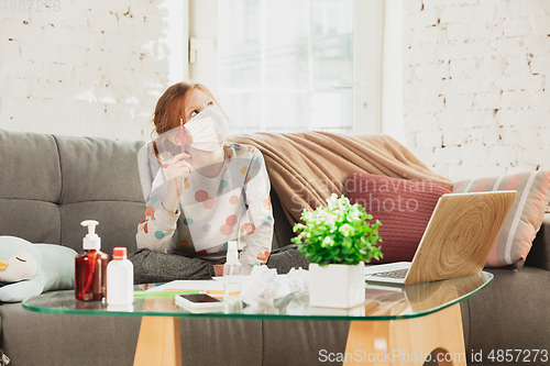 Image of Little girl in protective mask isolated at home with coronavirus symptoms, stop epidemic