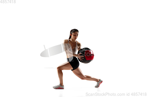 Image of Caucasian professional female athlete training isolated on white studio background. Muscular, sportive woman.