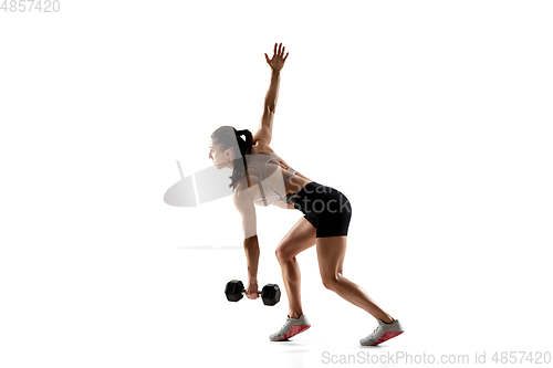 Image of Caucasian professional female athlete training isolated on white studio background. Muscular, sportive woman.