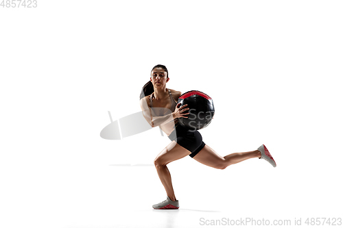 Image of Caucasian professional female athlete training isolated on white studio background. Muscular, sportive woman.