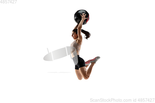 Image of Caucasian professional female athlete training isolated on white studio background. Muscular, sportive woman.