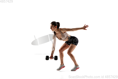 Image of Caucasian professional female athlete training isolated on white studio background. Muscular, sportive woman.