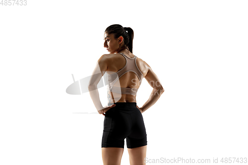 Image of Caucasian professional female athlete training isolated on white studio background. Muscular, sportive woman.