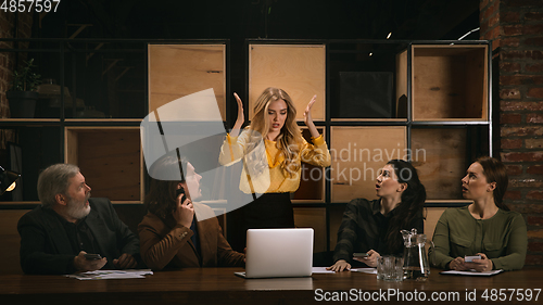 Image of Young colleagues working together in a office styled like classical artworks. Look busy, attented, cheerful, successful. Concept of business, office, finance.