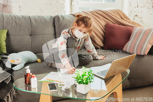 Image of Little girl in protective mask isolated at home with coronavirus symptoms, stop epidemic