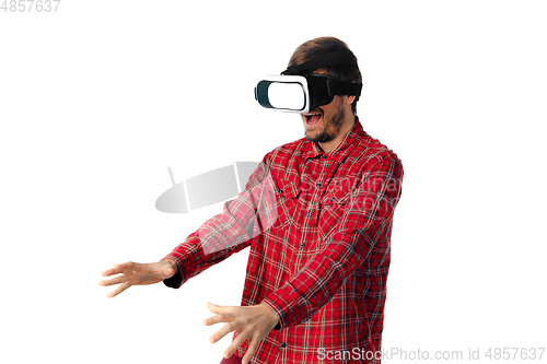 Image of Man emotional playing, using virtual reality headset isolated on white studio background