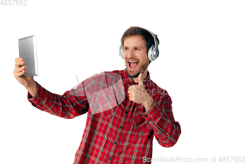 Image of Man using tablet and headphones isolated on white studio background