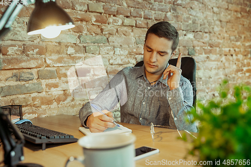 Image of Man working from home during coronavirus or COVID-19 quarantine, remote office concept