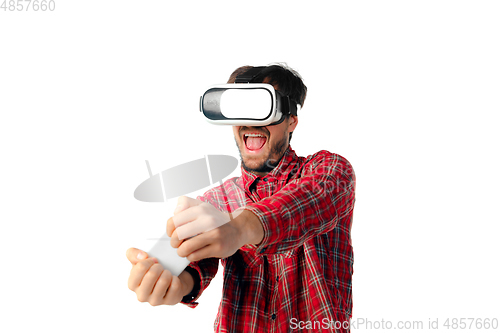 Image of Man emotional playing, using virtual reality headset isolated on white studio background