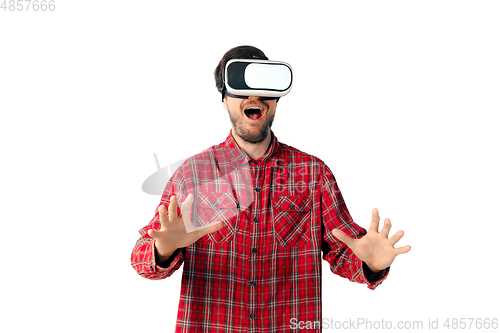 Image of Man emotional playing, using virtual reality headset isolated on white studio background