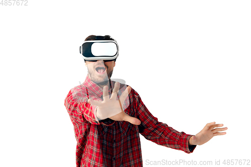Image of Man emotional playing, using virtual reality headset isolated on white studio background
