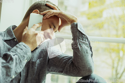 Image of Man working from home during coronavirus or COVID-19 quarantine, remote office concept