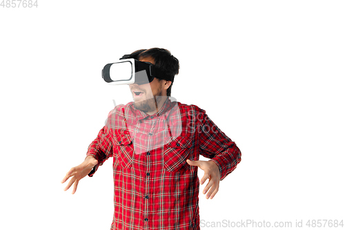 Image of Man emotional playing, using virtual reality headset isolated on white studio background