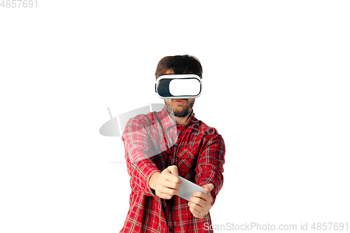 Image of Man emotional playing, using virtual reality headset isolated on white studio background