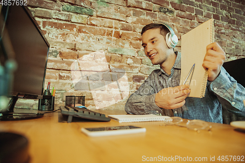 Image of Man working from home during coronavirus or COVID-19 quarantine, remote office concept