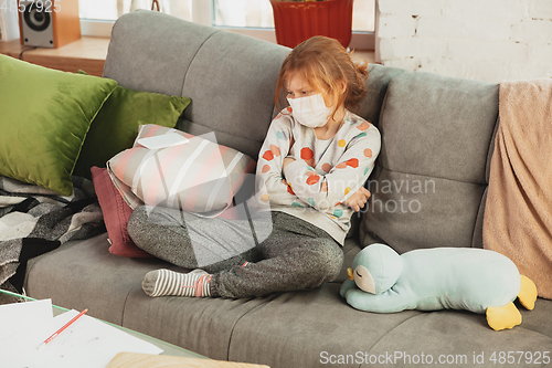 Image of Little girl in protective mask isolated at home with coronavirus symptoms, stop epidemic