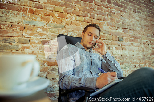 Image of Man working from home during coronavirus or COVID-19 quarantine, remote office concept