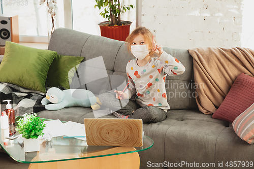 Image of Little girl in protective mask isolated at home with coronavirus symptoms, stop epidemic