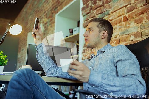 Image of Man working from home during coronavirus or COVID-19 quarantine, remote office concept