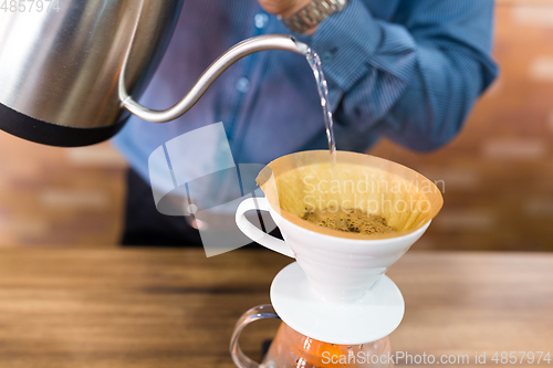 Image of Barista Pouring water on coffee filter