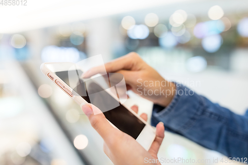 Image of Woman working on cellphone