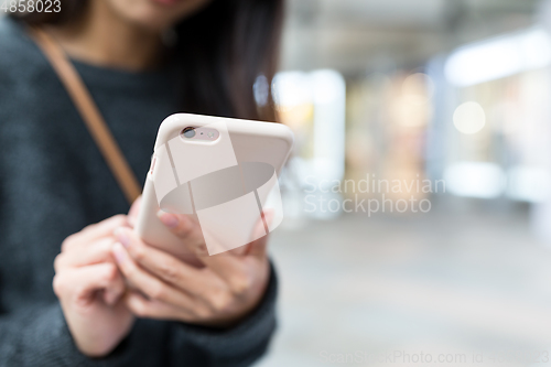 Image of Woman working on cellphone