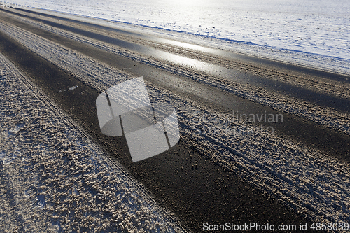 Image of Snow covered asphalt road