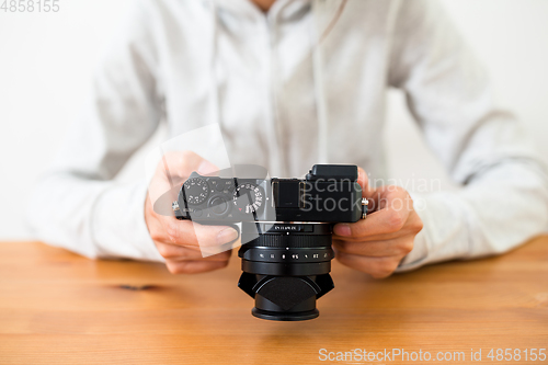Image of Woman checking on digital camera