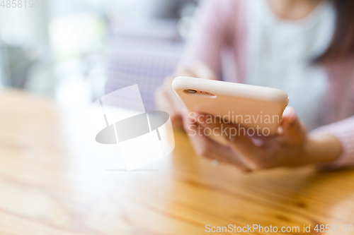 Image of Woman using mobile phone for online