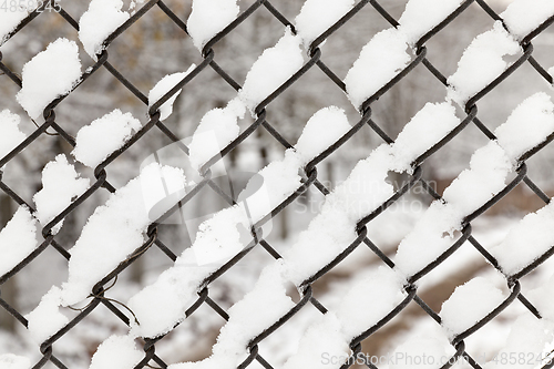 Image of metal grating covered snow
