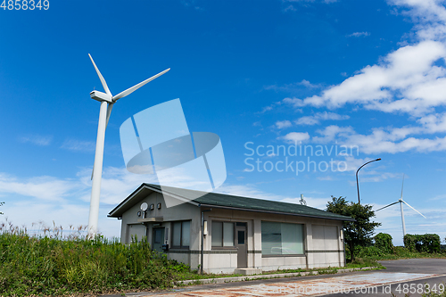 Image of Wind turbine and house