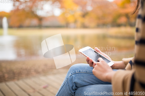 Image of Woman use of mobile phone in Park