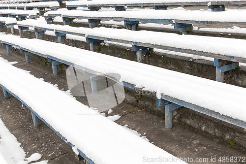 Image of wooden bench under the snow