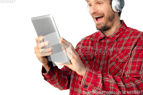 Image of Man using tablet and headphones isolated on white studio background