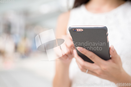 Image of Woman surfing internet on mobile phone