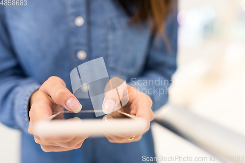 Image of Woman working on cellphone