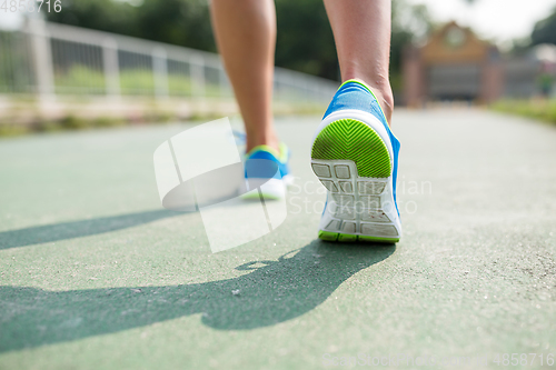 Image of Woman run in a city