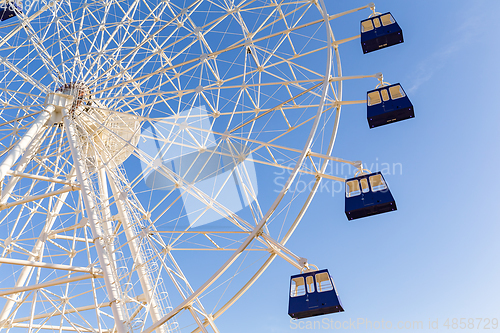 Image of Ferris wheel with blue sky