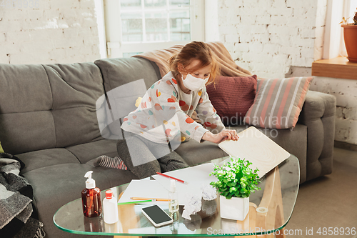 Image of Little girl in protective mask isolated at home with coronavirus symptoms, stop epidemic
