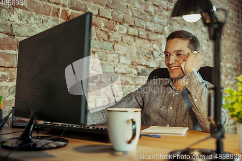 Image of Man working from home during coronavirus or COVID-19 quarantine, remote office concept