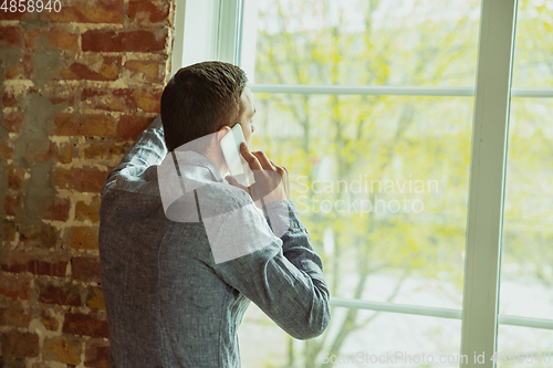 Image of Man working from home during coronavirus or COVID-19 quarantine, remote office concept