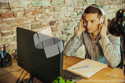 Image of Man working from home during coronavirus or COVID-19 quarantine, remote office concept