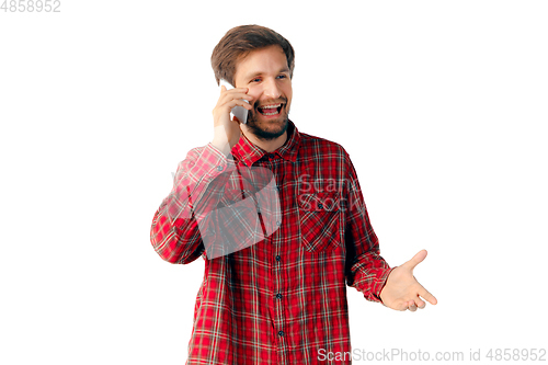 Image of Emotional man using smartphone isolated on white studio background