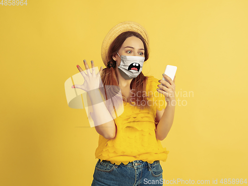 Image of Portrait of young caucasian woman with emotion on her protective face mask