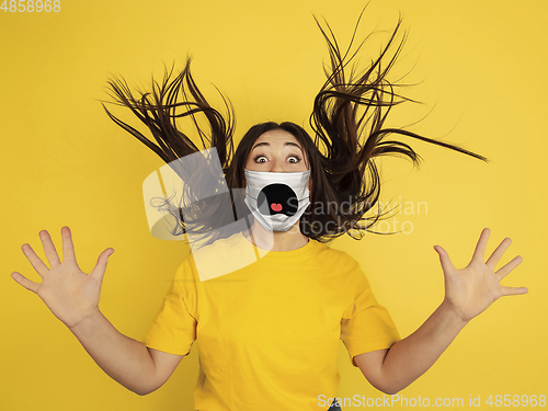 Image of Portrait of young caucasian woman with emotion on her protective face mask