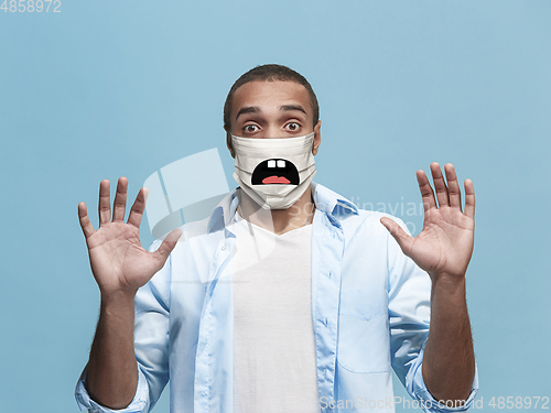 Image of Portrait of young african-american man with emotion on his protective face mask