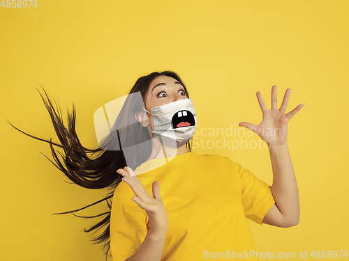 Image of Portrait of young caucasian woman with emotion on her protective face mask