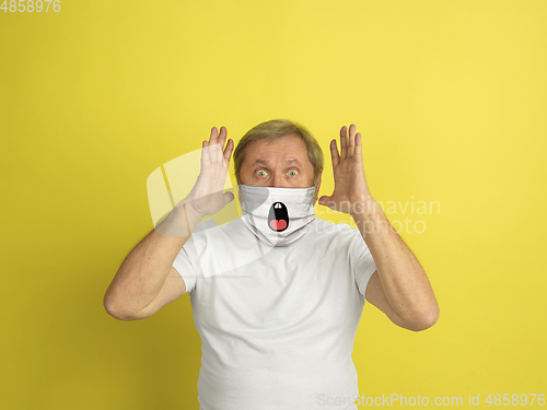 Image of Portrait of caucasian senior man with emotion on his protective face mask