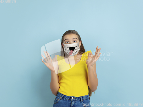 Image of Portrait of young caucasian girl with emotion on her protective face mask