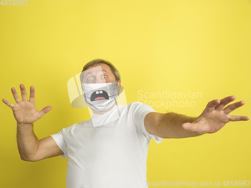 Image of Portrait of caucasian senior man with emotion on his protective face mask